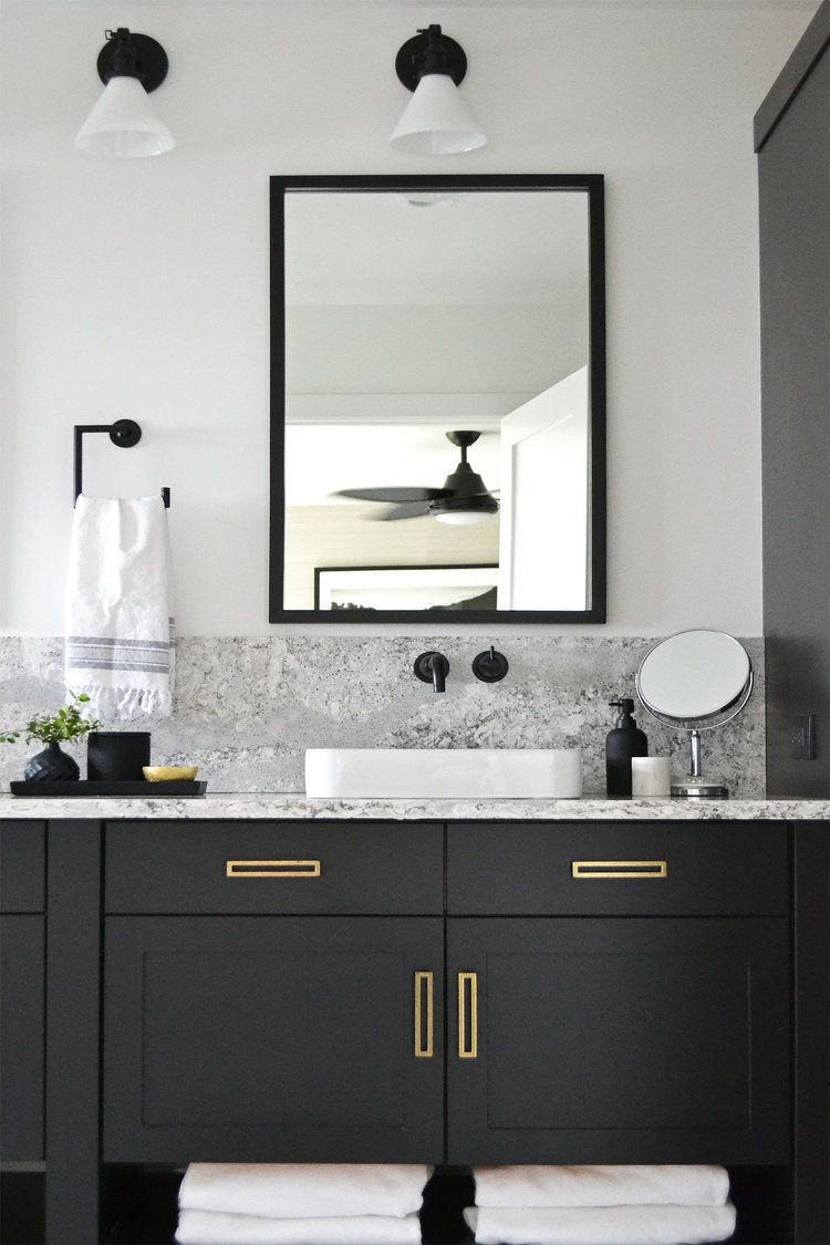 Black And White Bathroom Vanity
 Modern bathroom with black vanity and brass hardware