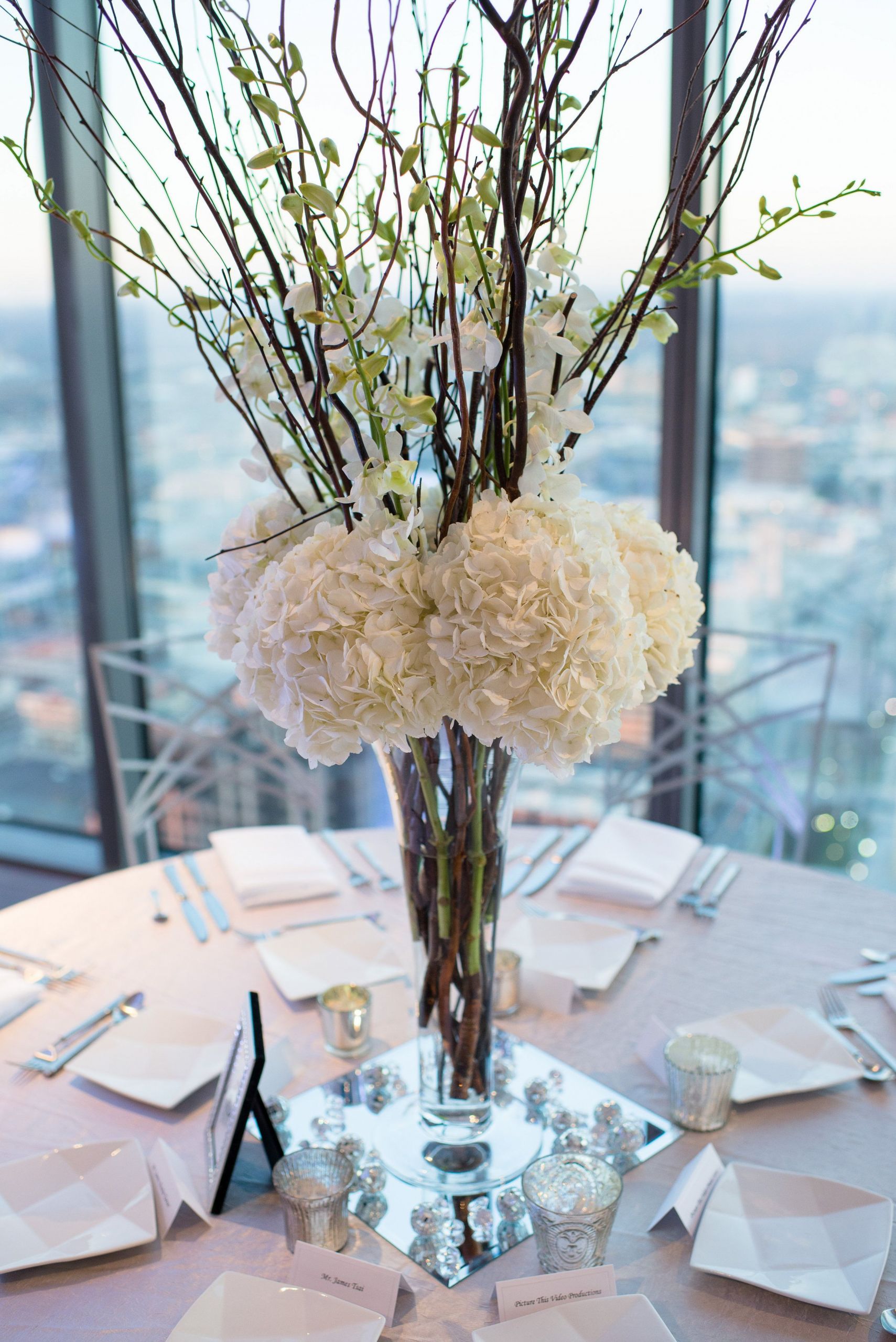 Cost Of Flowers For Wedding
 tall wedding centerpiece with hydrangeas and orchids