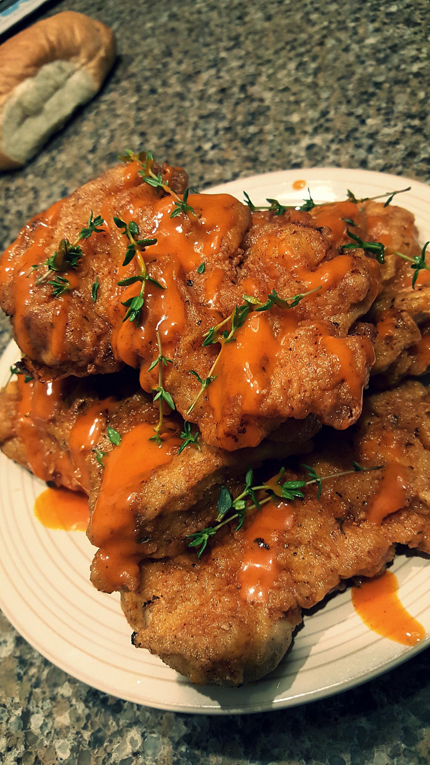 Deep Fried Chicken Thighs Recipe
 deep fried chicken thighs with hot sauce and thyme sprigs