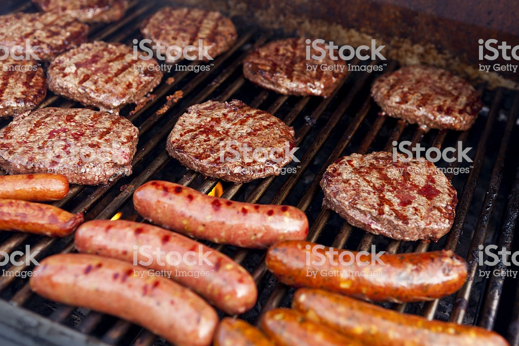 Hamburgers On The Grill
 Barbeque Grill With Hamburgers Hot Dogs And Sausage stock