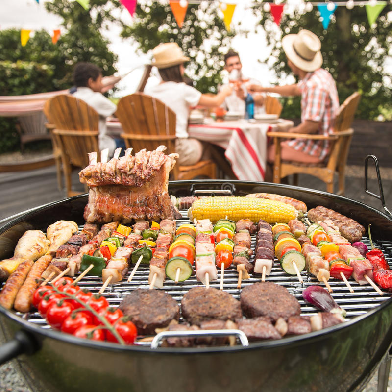 Summer Barbecue Party Ideas
 Family Having A Barbecue Party In Their Garden Stock