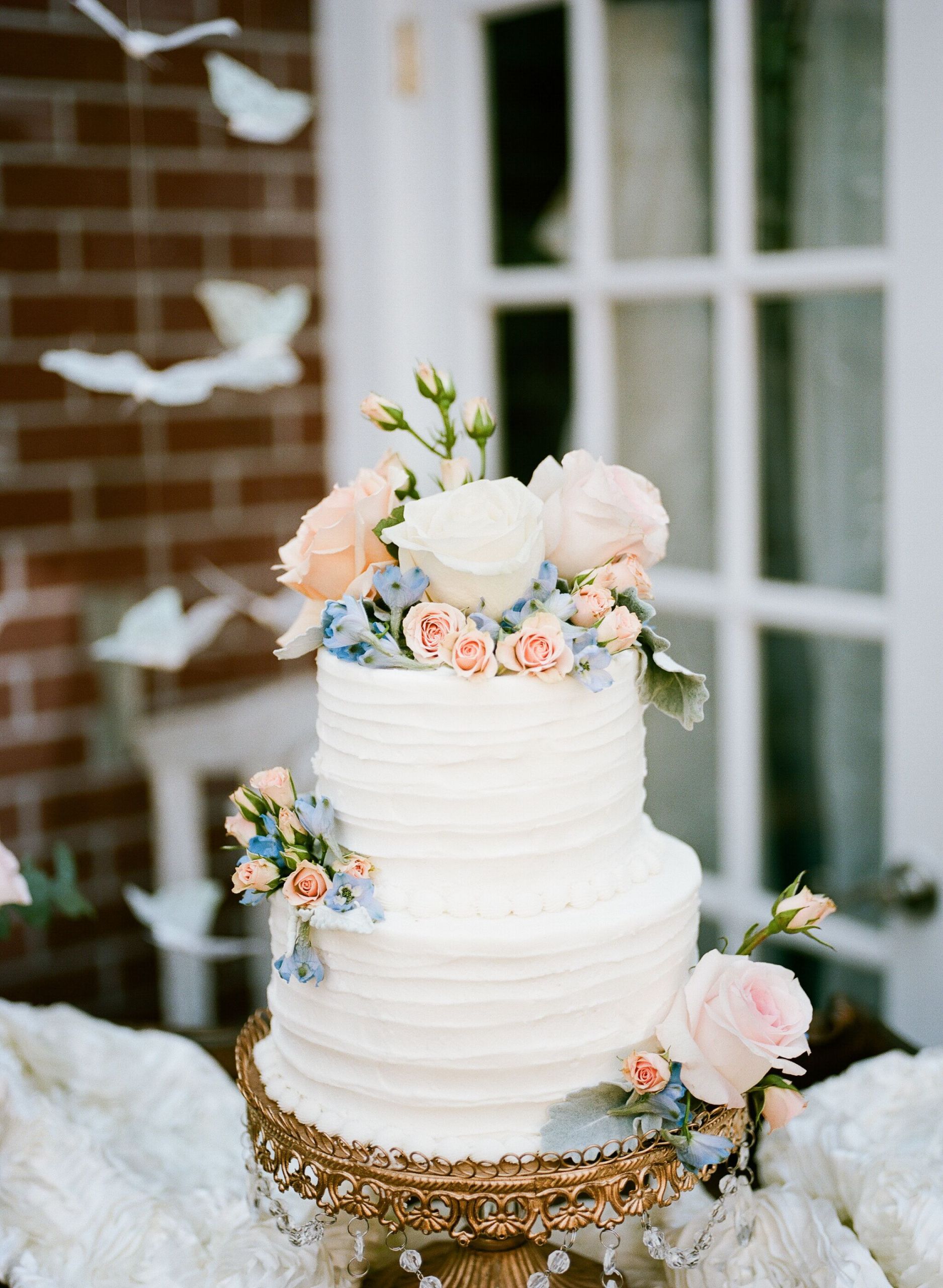 Wedding Cake With Flowers
 Buttercream Wedding Cake With Blush and Blue Flowers